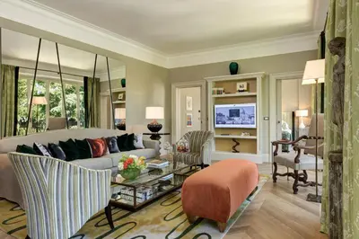 a living room with a couch and a table at Rocco Forte Hotel De Russie in Rome