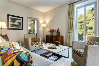 a living room with a couch and a table at Rocco Forte Hotel De Russie in Rome
