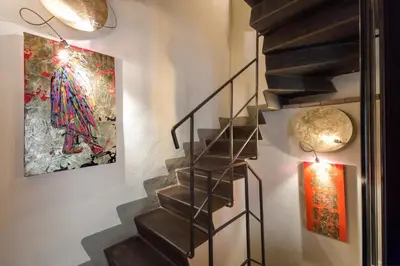 a staircase in a house with a painting on the wall at Residenza Torre Colonna in Rome