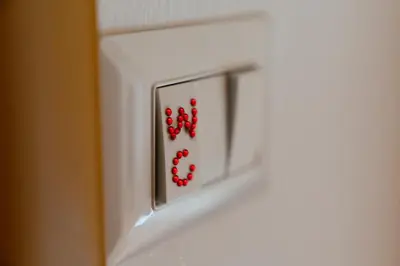 a bunch of red dice on a white door at Merulana Star in Rome
