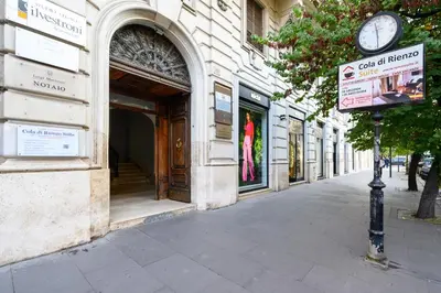 a clock on a pole in front of a building at Cola Di Rienzo Suite Guest House in Rome