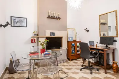 a living room with a glass table and a television at The Five Oscars Inn in Rome