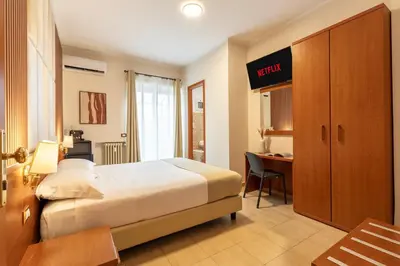 a hotel room with a bed and a desk at AlbaDomus Affittacamere o GuestHouse in Rome