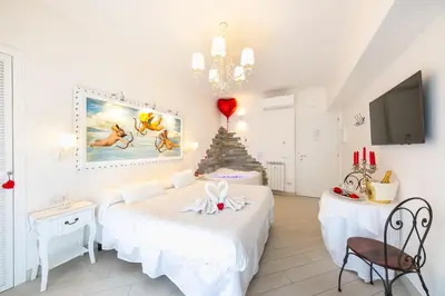 a bedroom with two beds and a christmas tree at Suites Roma Tiburtina Elegance in Rome