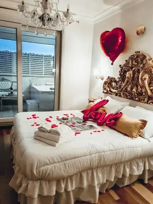 a bedroom with a bed with a heart balloon on it at Suites Roma Tiburtina Elegance in Rome