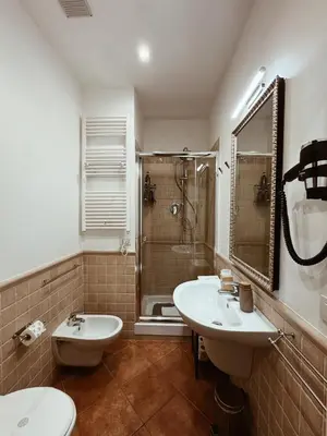 a bathroom with a toilet and a sink and a shower at Residenza Sciarra Suites in Rome