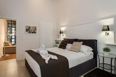 a bedroom with a bed with a towel on it at Margana Suite in Rome