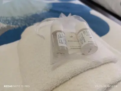 a bottle on top of towels on a table at Casa di Angela in Rome