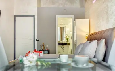 a room with a bed and a table with cups of coffee at Hub Pantheon in Rome