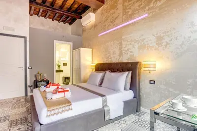 a bedroom with a large bed and a glass table at Hub Pantheon in Rome