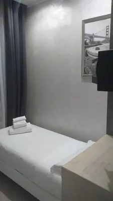 a room with a bed and a picture on the wall at Frattina Grand Suite Guesthouse in Rome