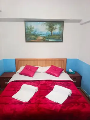 a large bed with red and white pillows on it at Host Roma in Rome
