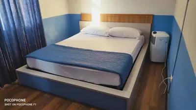 a bed in a small room with a blue wall at Host Roma in Rome