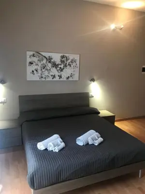 a bedroom with a bed with two towels on it at Room 14 in Rome
