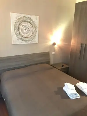 a bedroom with a bed with two towels on it at Room 14 in Rome