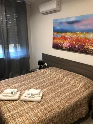 a bedroom with a bed with two towels on it at Room 14 in Rome