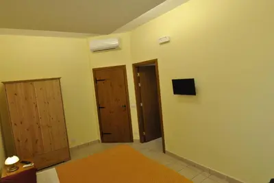 a room with two doors and a tv on the wall at Roma Tourist House in Rome