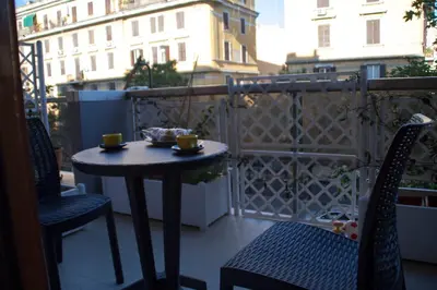 a small table and chairs on a balcony at DaNoi in Trastevere in Rome