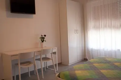 a bedroom with a table and two chairs and a bed at DaNoi in Trastevere in Rome