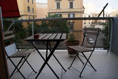 a table and two chairs on a balcony with a view at DaNoi in Trastevere in Rome