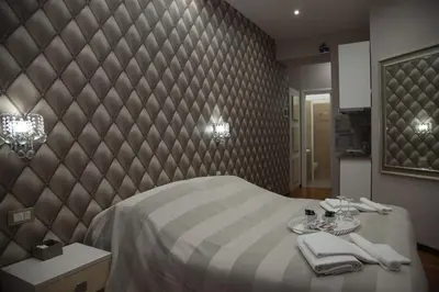 a bedroom with a bed with towels and a mirror at Maison Imperiale in Rome