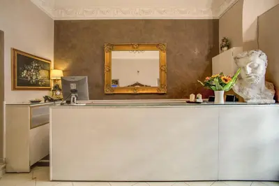 a kitchen with a bust of a man on a counter at Hotel Caravaggio in Rome