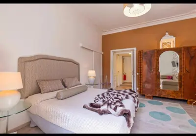 a bedroom with a bed and a large mirror at Vatican View Apartment in Rome