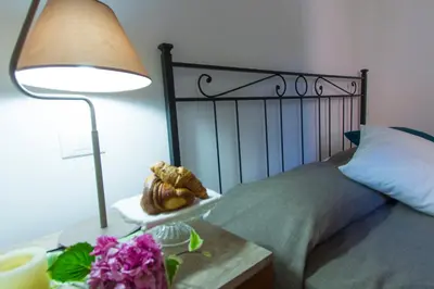 a bedroom with a bed and a table with a lamp at Bausan 12 in Rome