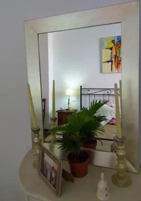 a bedroom with a mirror and a table with a plant at Bausan 12 in Rome