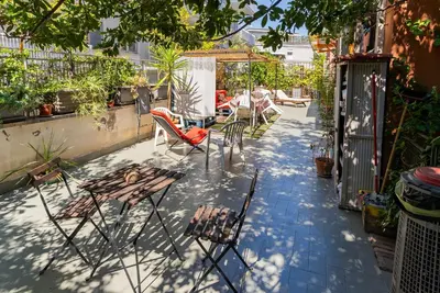 a patio with chairs and tables on a patio at Bausan 12 in Rome
