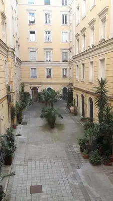 an empty courtyard in front of a large building at Residenza Vatican Suite in Rome