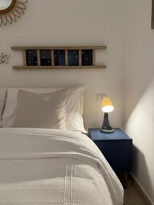 a bedroom with a bed and a lamp on a nightstand at Green Rooms Trastevere in Rome