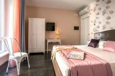 a bedroom with a bed and a chair and a table at Rome Visits in Rome