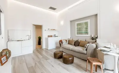a white living room with a couch and a table at Thebestinrome Piazza di Spagna in Rome
