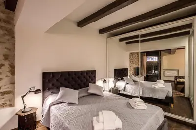 a bedroom with two beds and a mirror at Trinità dei Monti Suite in Rome