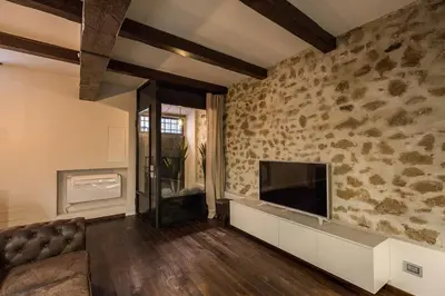 a living room with a couch and a flat screen tv at Trinità dei Monti Suite in Rome