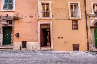 an old building with an open door on a street at Trinità dei Monti Suite in Rome