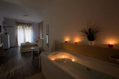 a large bathroom with a tub with candles in it at Luxury House Vaticano in Rome