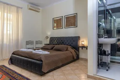 a bedroom with a large bed and a sink at Camere del Camerlengo in Rome