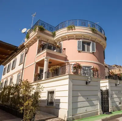 a pink building with a balcony on top of it at The Bricks Rome in Rome