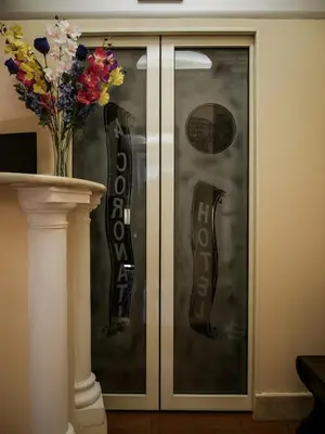 a glass door with a pair of shoes on it at Hotel 4 Coronati in Rome