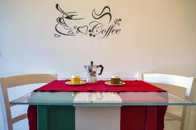 a table with a coffee maker and two cups on it at Vatican Attic With Terrace in Rome