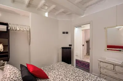 a bedroom with a bed and a mirror and a dresser at Campo de' Fiori Stylish White in Rome