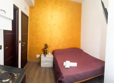 a small room with a bed and a yellow wall at Residenza Monteverde in Rome