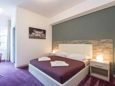 a bedroom with a bed with two towels on it at Guesthouse Park Pines in Rome