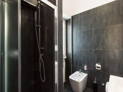 a bathroom with a shower and a toilet and a sink at Guesthouse Park Pines in Rome
