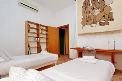 a living room with two beds and a desk at Romalibera in Rome