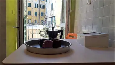 a kitchen counter with a coffee pot and cups on it at Apartment Ostiense Piramide Station in Rome
