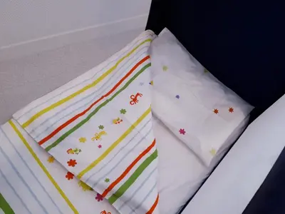 two white pillows with rainbow patterns on them at Apartment Ostiense Piramide Station in Rome