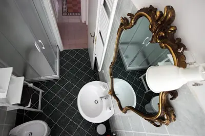a bathroom with a sink and a mirror at Apartment Ostiense Piramide Station in Rome
